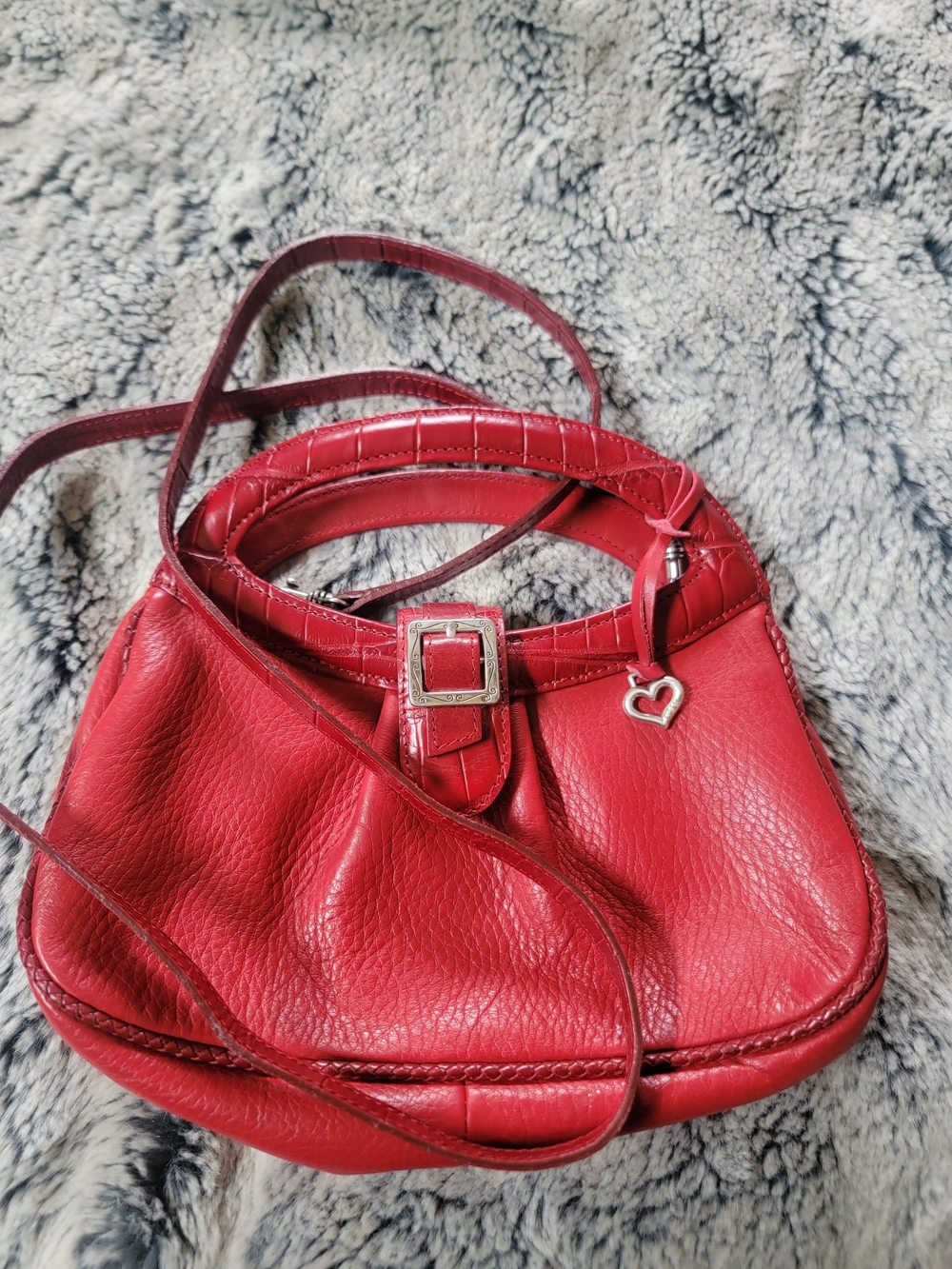 Brighton red leather handbag with a silver heart charm.